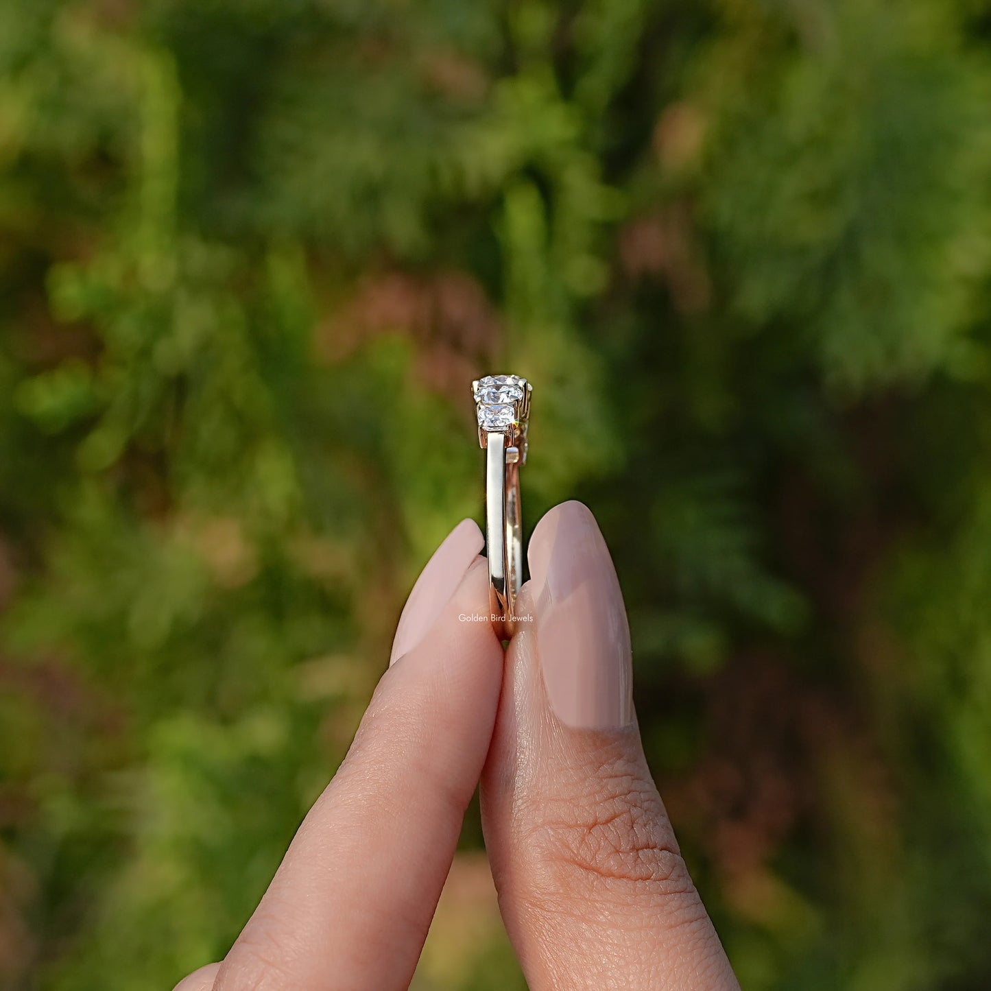 Side View of Round Cut Lab Grown Diamond Ring In two fingers