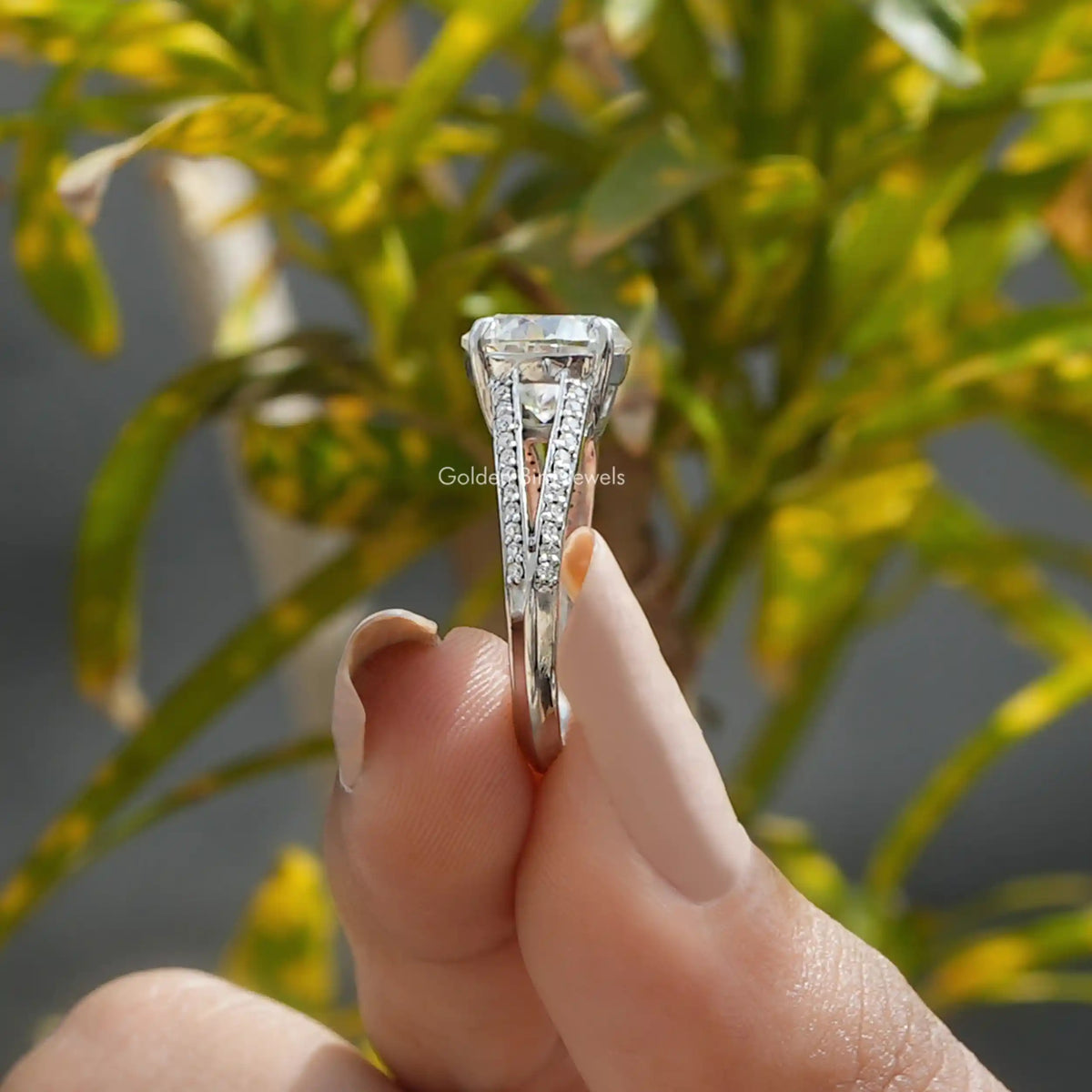 Side View of Round Cut Moissanite Ring In two fingers