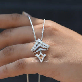In hand showing a view of moissanite designer pendant	 		

