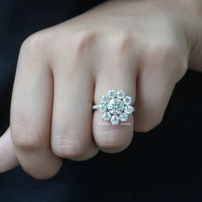 View of Round Cut Floral Halo Engagement Ring In Finger