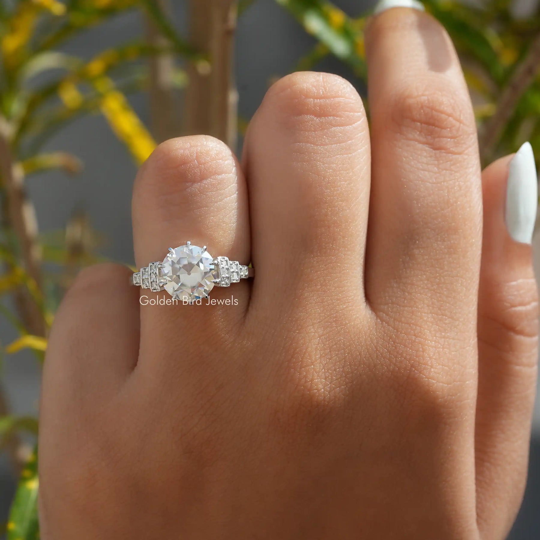 [In finger front view of round cut accent stone ring made of colorless color]-[Golden Bird Jewels]