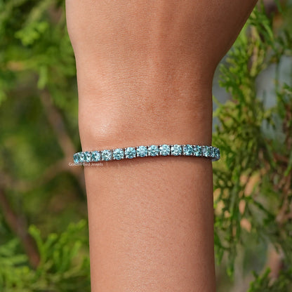 In Hand Showing View Of Blue Round Cut Moissanite Tennis Bracelet