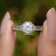 Front View of Old European Round Cut Moissanite Solitaire Ring In two Fingers