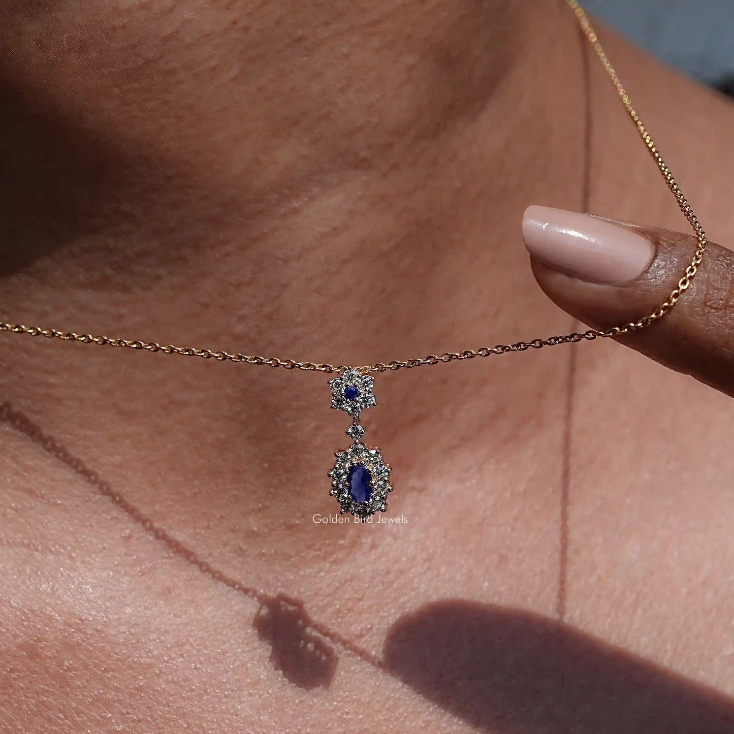 wear in women's Sapphire Blue Oval Cut Gemstone Halo Pendant 