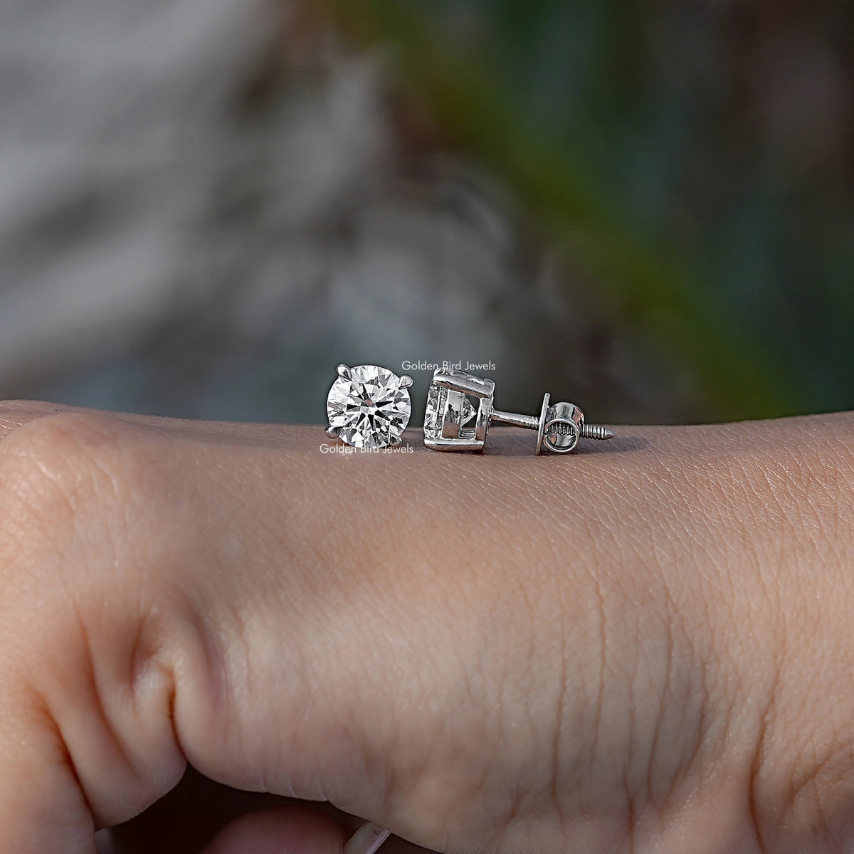 Round-cut solitaire stud earring with clear stone in silver-toned prong setting