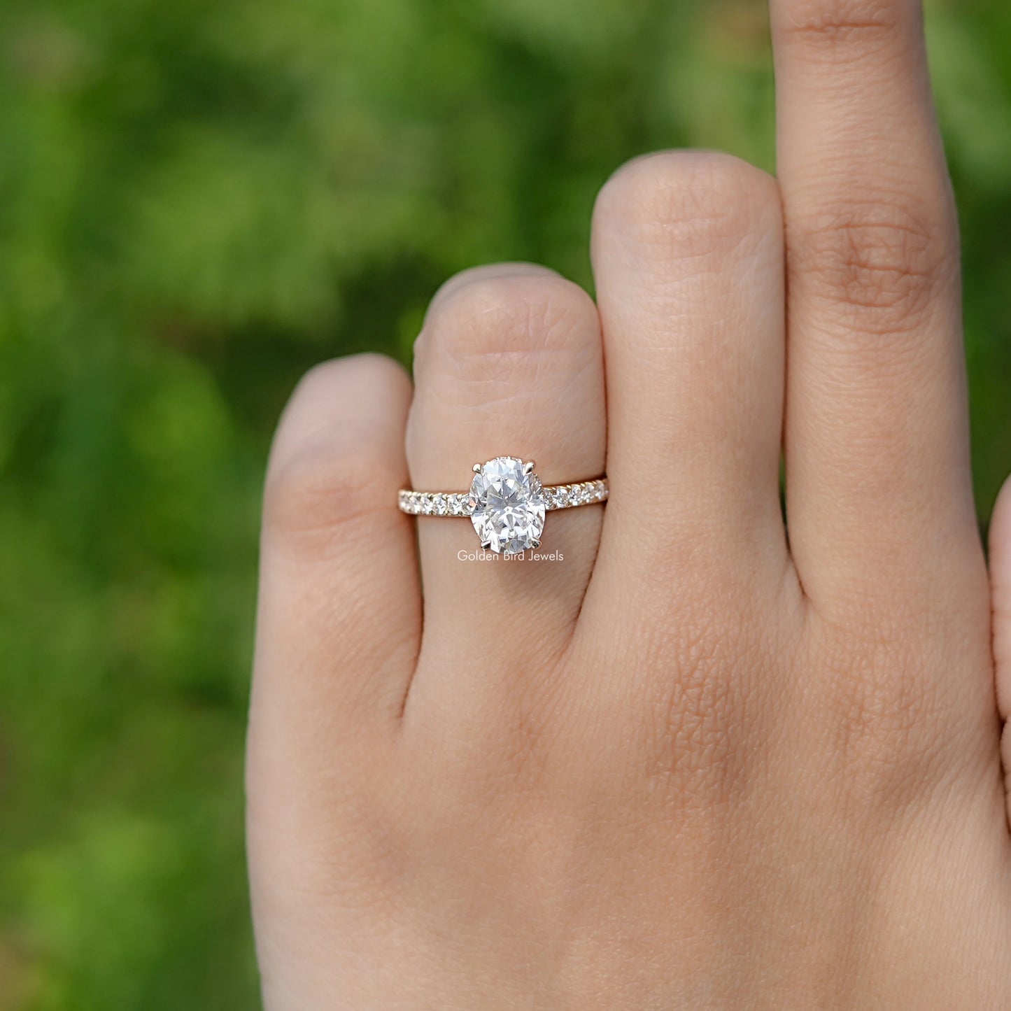 In finger front view of Oval Moissanite Bridge Cut Moissanite ring 
