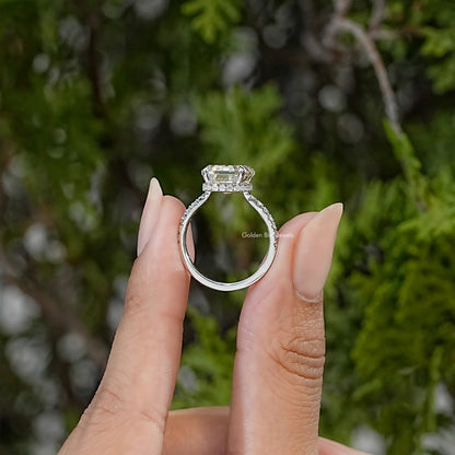 Side view of sterling silver ring showing elevated emerald-cut stone and accent-set band