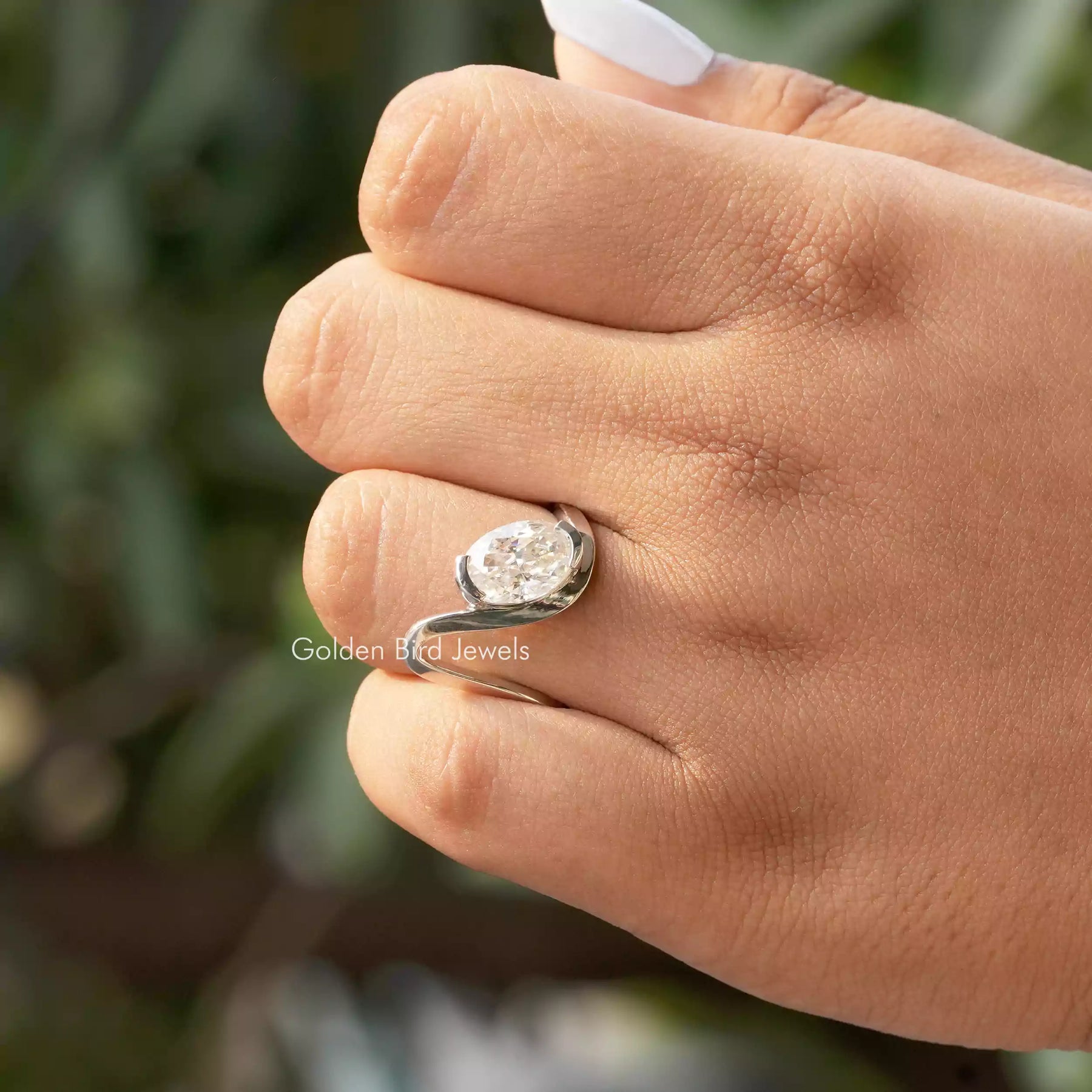 Close-Up View of Oval Cut Moissanite Curved Ring In White Gold