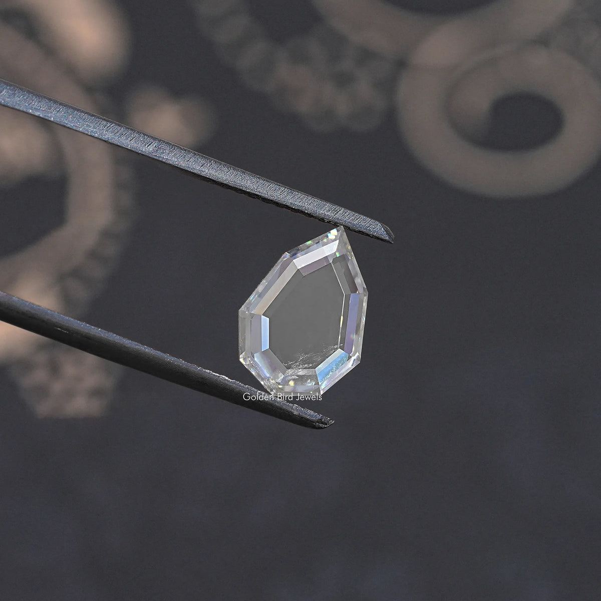 Faceted clear moissanite loose gemstone held with metal tweezers, step-cut style.