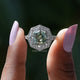 Two fingers holding the Step Cut Cushion Moissanite Milgrain Ring