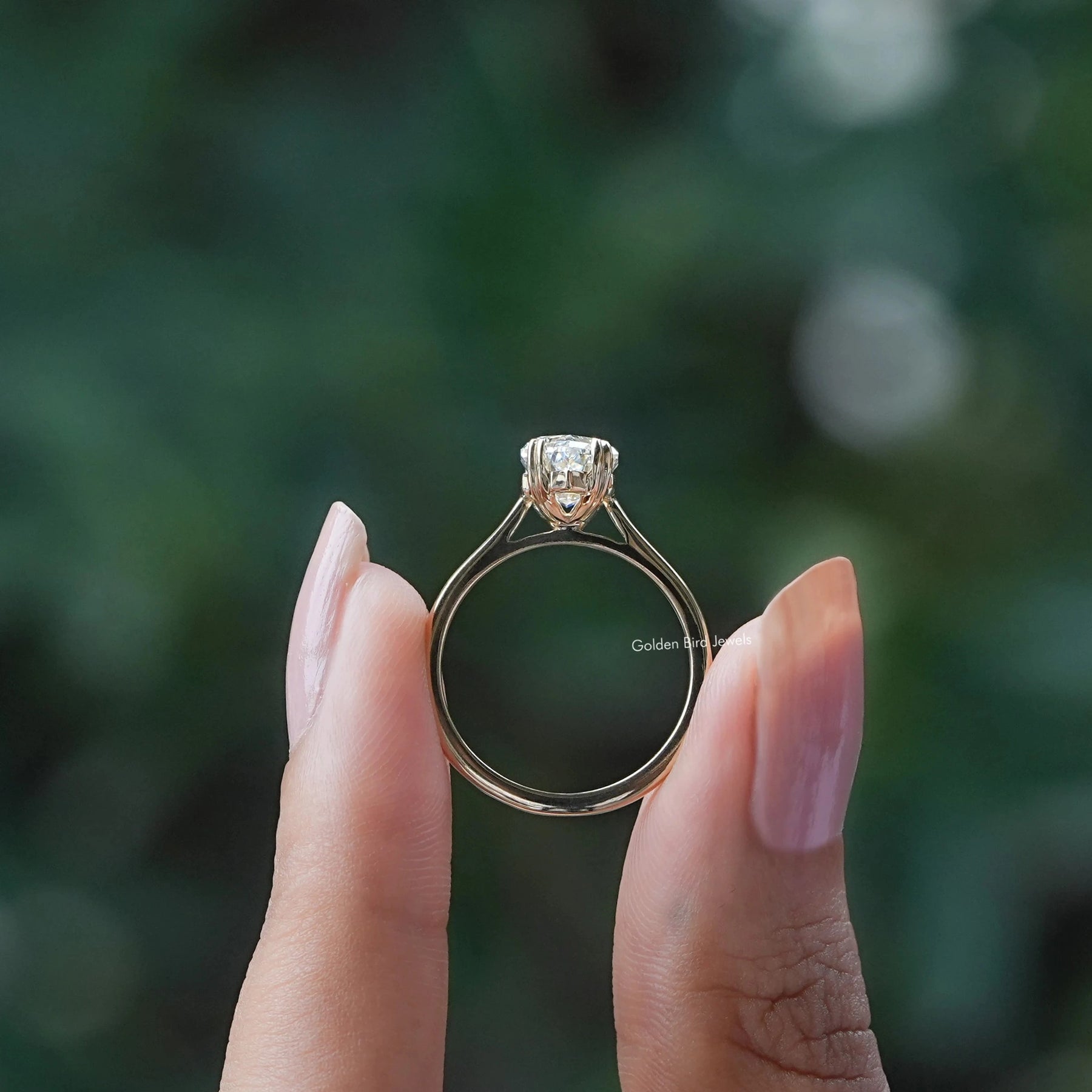 Back view A step cut dutch marquise diamond ring in two fingers