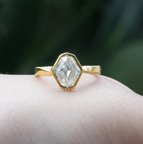 View of Bezel Set Step Cut Moval Engagement Ring In Yellow Gold