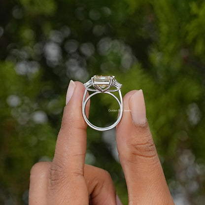 Side view of a sterling silver engagement ring showing its raised Asscher-cut center stone and setting