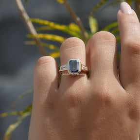 Detailed View Of Emerald Cut Moissanite Bezel Set Ring In Yellow Gold