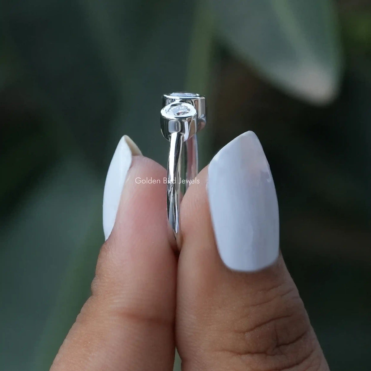 Side View of Round Cut Moissanite Engagement Ring In two fingers