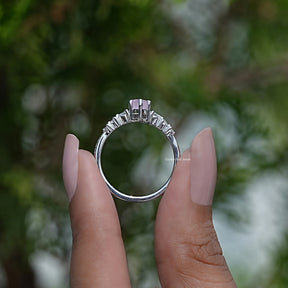 Back View of Emerald Cut Blue Topaz Gemstone Halo Ring in two fingers