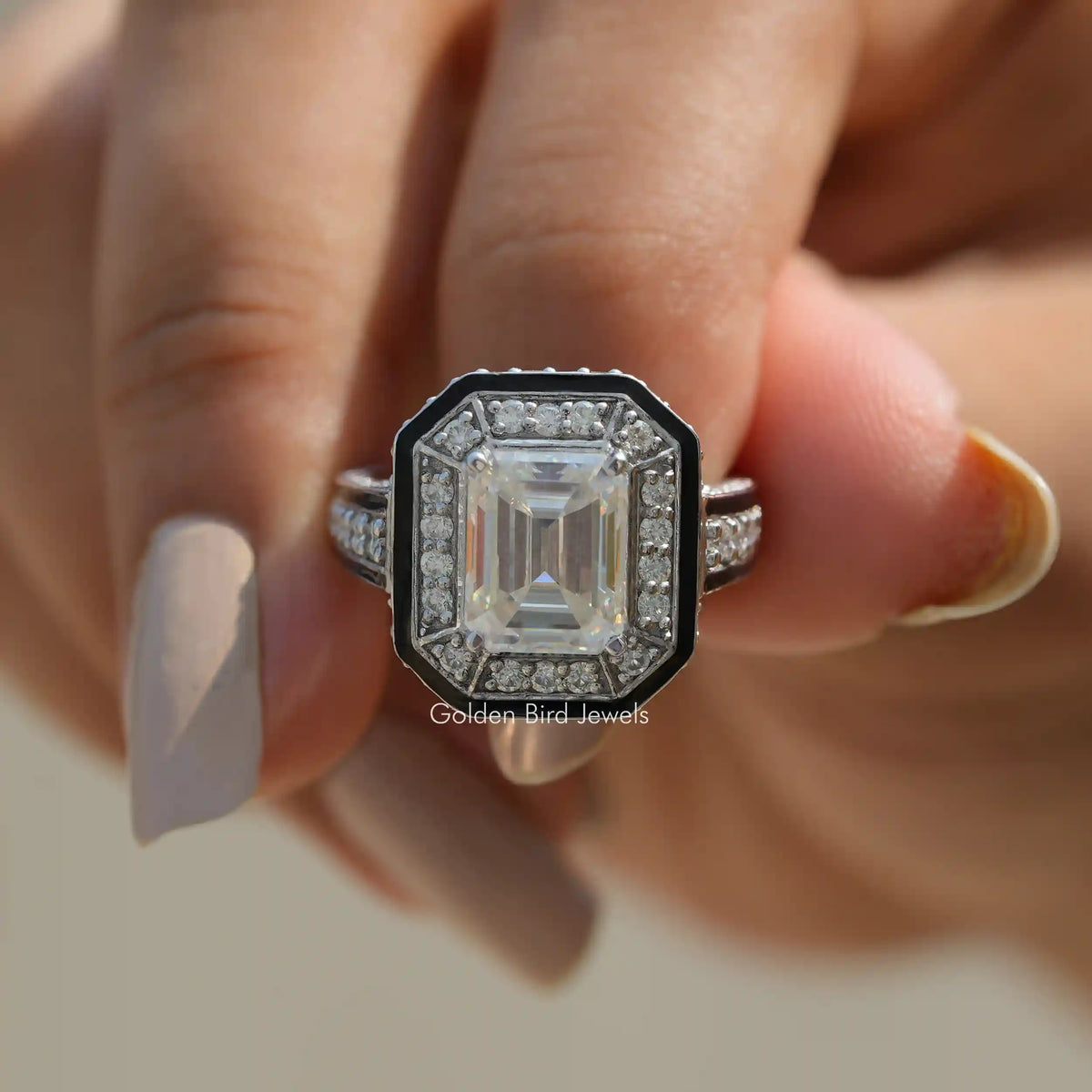 In finger front view of Moissanite Emerald Cut Halo Engagement Ring in white gold