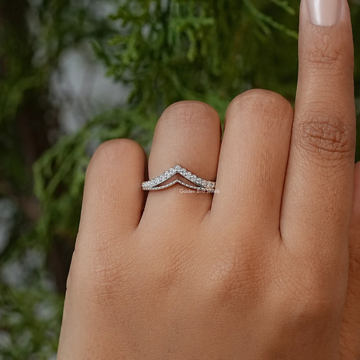 Silver V-shaped chevron band with round stones and polished metal edges