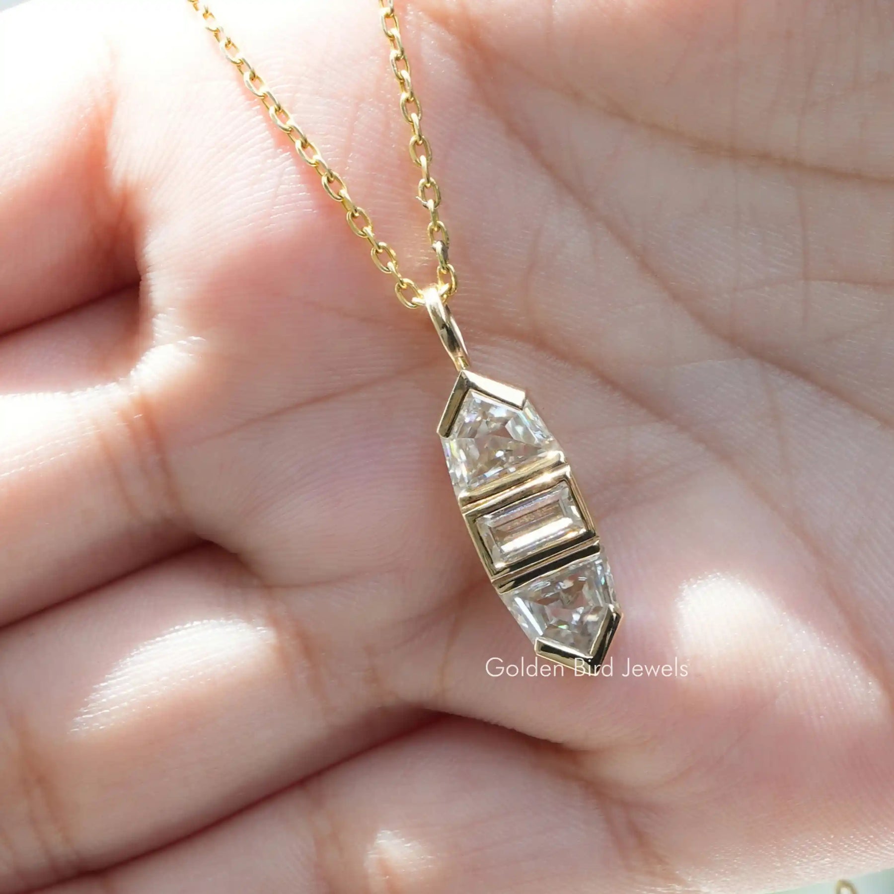 [In hand front view of yellow gold baguette cut pendant]-[Golden Bird Jewels]