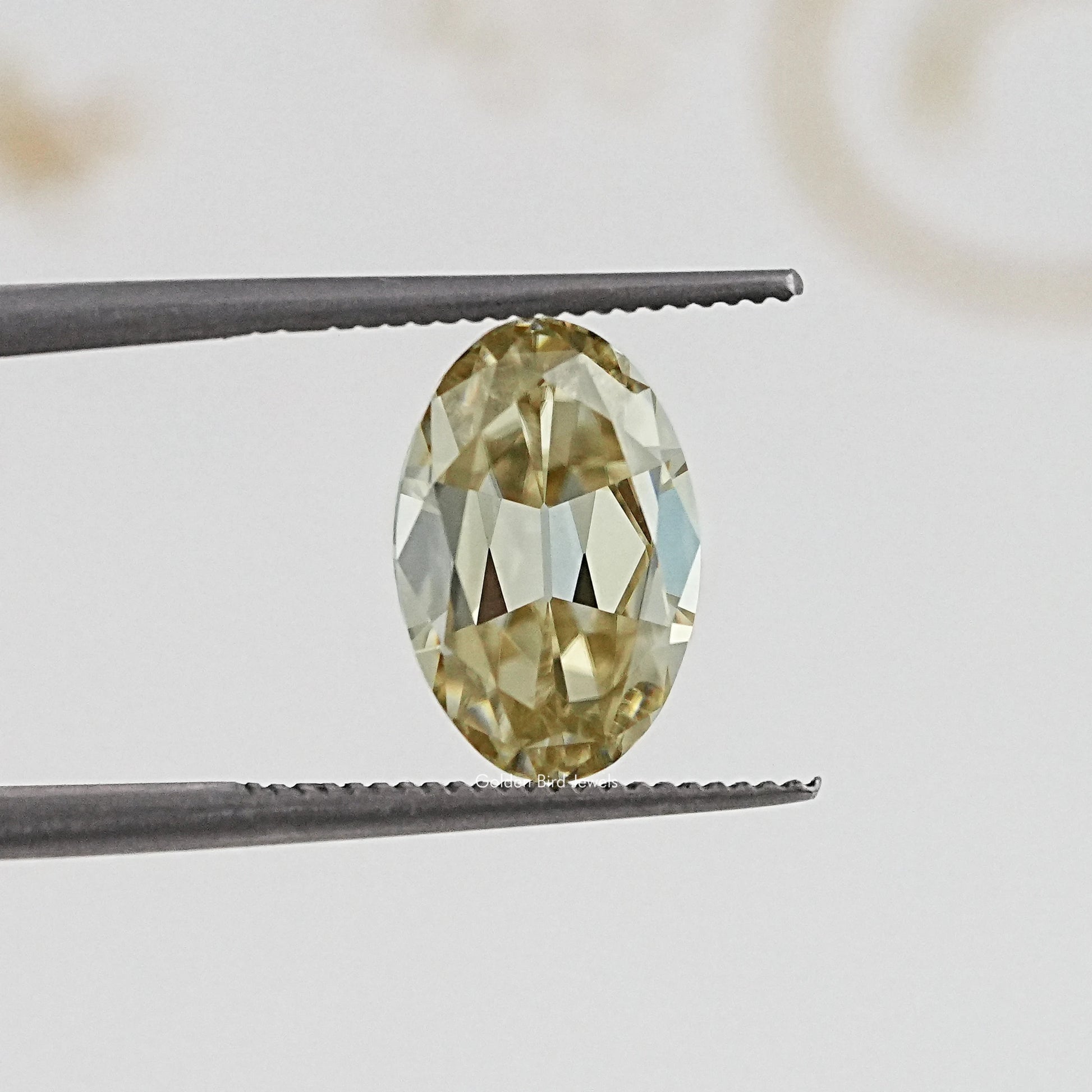 In Tweezer View Of Old Mine Oval Cut Loose Moissanite Stone