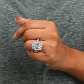 View of Moissanite Criss Cut Colorless Moissanite Halo Engagement Ring In Finger