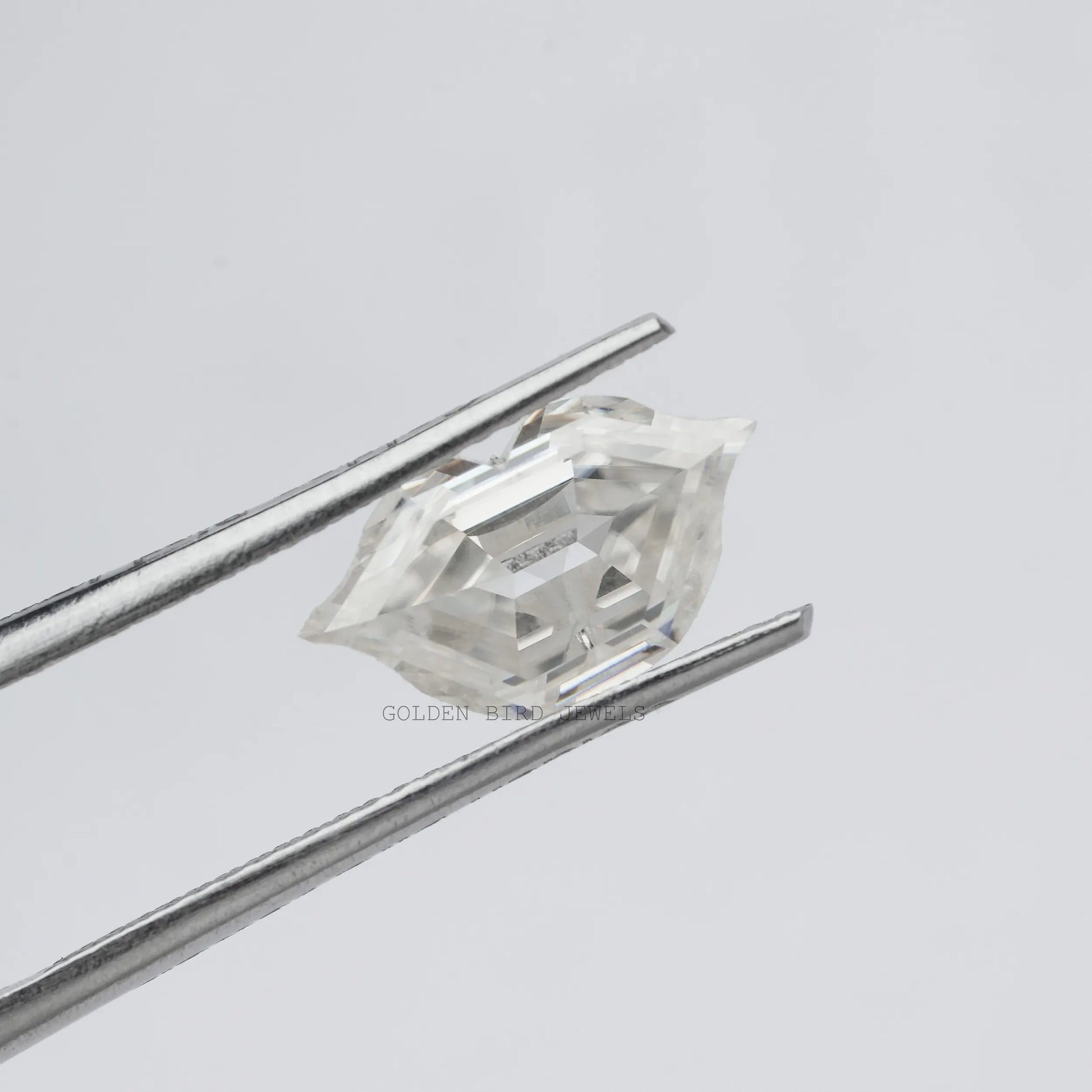 Front view of the tweezer Holding Antique Lips Loose Moissanite Stone In White color 
